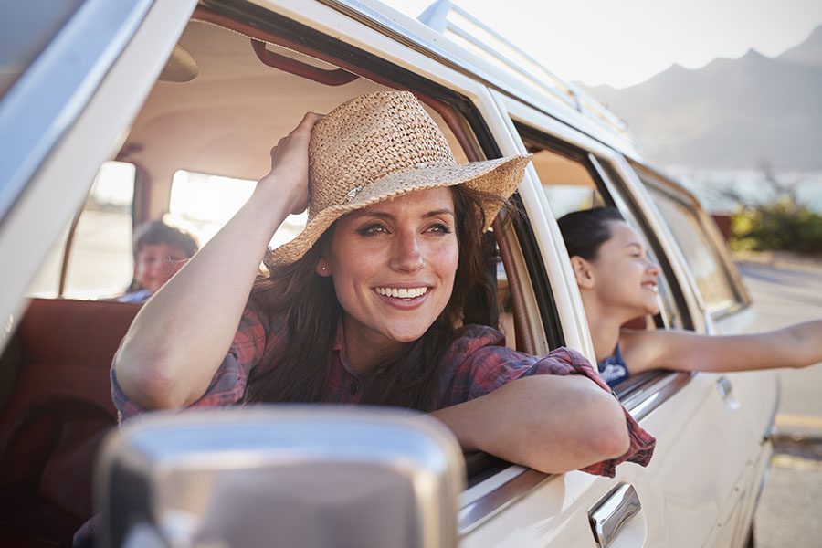 About Our Agency - Mother And Children Having Fun and Relaxing In a Classic Car During a Road Trip